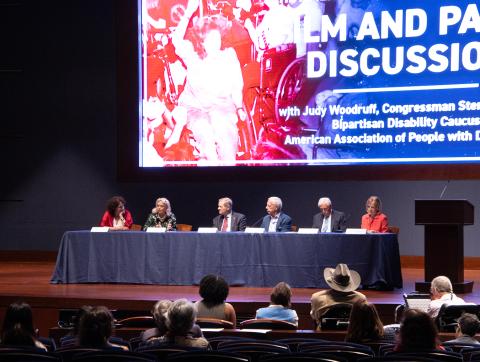 Panelists sit on the stage for the ADA event