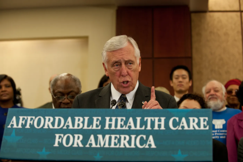 Congressman Steny Hoyer behind a sign that says "Affordable Health Care for America"